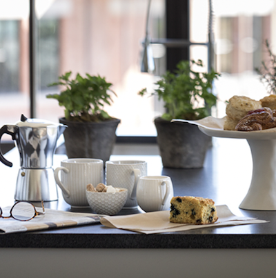 Rich Hospitality close-up of a tea set and muffins