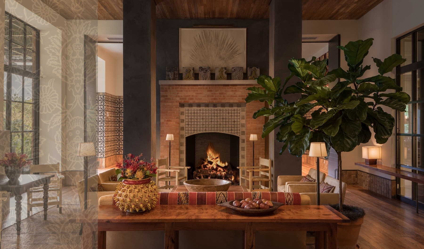 Sublime & Spirited lounge with a modern fireplace, ample seating, bright lighting on wooden accents and with easy-to-navigate through spacial areas