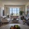 bright living room area with wood-style flooring and with wall art and decor