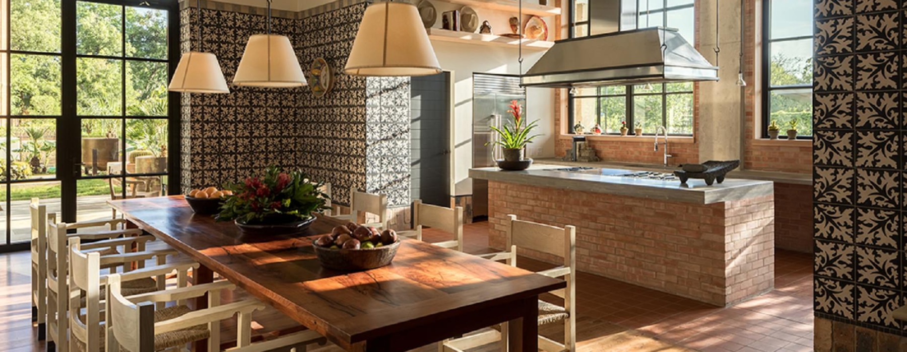 bright kitchen with a large wooden table and warm lighting