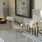 bathroom with a large mirror, prepared bathroom items and ample lighting