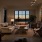 wide living room with modern decor, wall art, and a bright lighting through the  windows providing access to dining