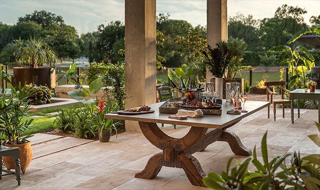 Indulgent Details outside patio area with lush landscaping